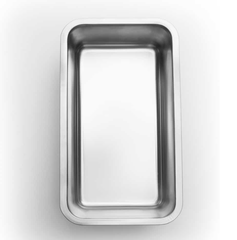 A top view of a clean, empty stainless steel rectangular tray with a shallow depth, featuring smooth edges and a reflective surface—an inviting stage ready to showcase your healthy lemon loaf recipe.